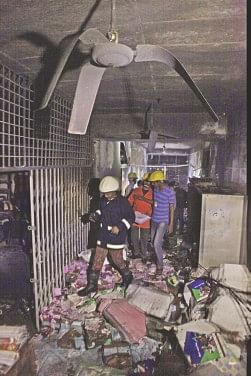 Fire fighters inspecting a damaged room.  Photo: Rashed Shumon