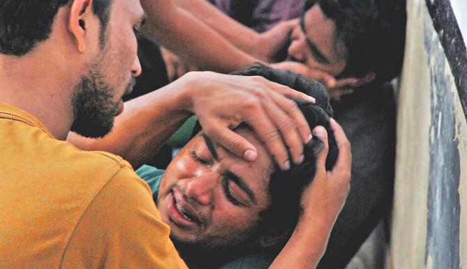 Classmates break down in tears as Taposh Paul, a first-year CU student shot in a factional clash of BCL, is declared dead at CMCH yesterday.  Photo: Anurup Kanti Das
