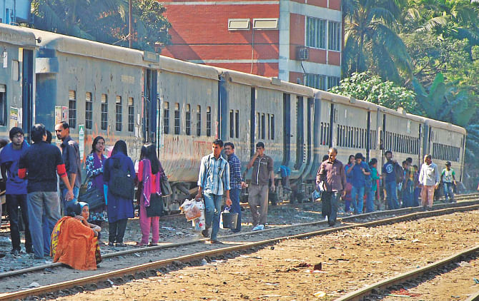 Students of Chittagong University waiting around their shuttle train yesterday after criminals cut the high air pressure pipes of the train's brakes. The photos were taken at the Shalashahar Railway Station. Photo: Star