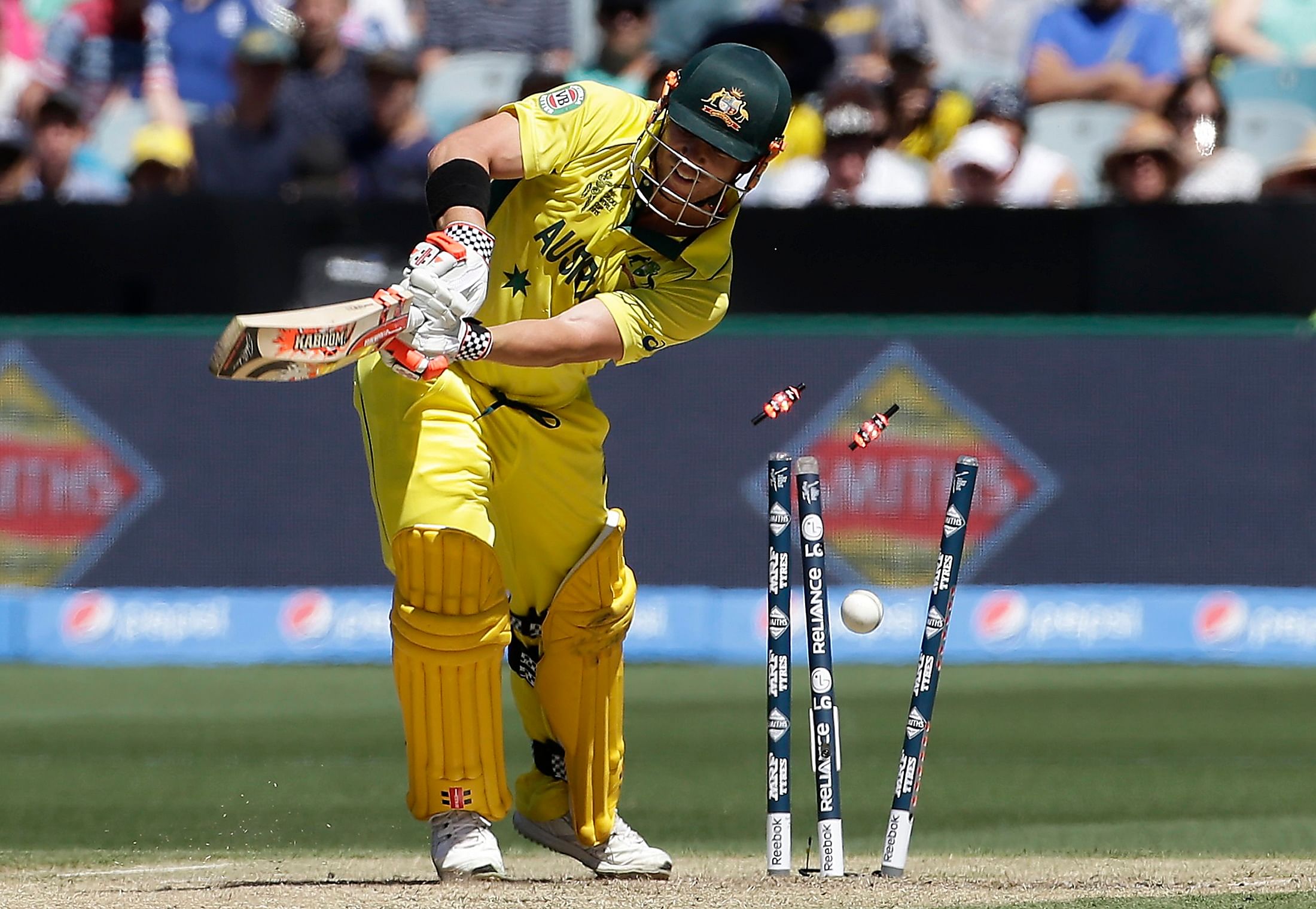 Australia's David Warner is bowled for 22 runs by England's Stuart Broad during their Cricket World Cup match at the Melbourne Cricket Ground (MCG) February 14, 2015. Photo: Reuters