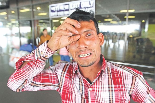 Deported Md Ilias in tears at Hazrat Shahjalal Airport yesterday. He spent several lakhs to go to Oman but did not even get a Tk 10,000 salary a month.  Photo: Palash Khan