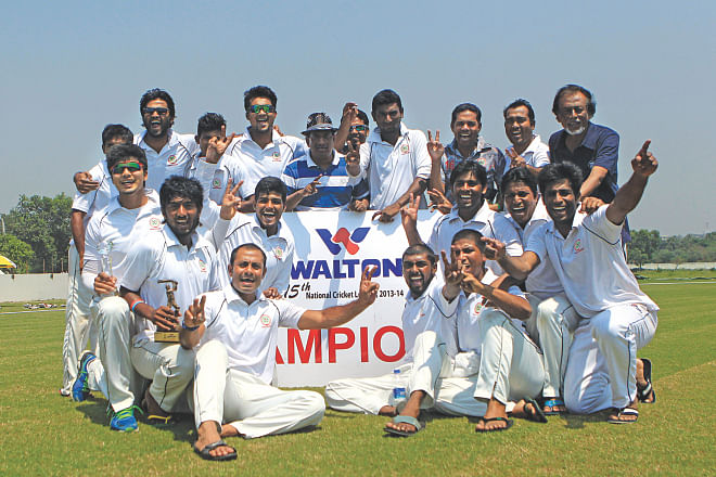 Players and officials of Dhaka celebrate after becoming champions in the National Cricket League at Cox's Bazar yesterday. PHOTO: STAR