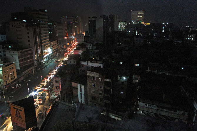Dhaka loses its neon glitz and even the street lights and all that is bright are headlights of cars and a few buildings powered by generators. The photo of Kazi Nazrul Islam Avenue was taken at Farmgate during the blackout yesterday evening. Photo: Amran Hossain