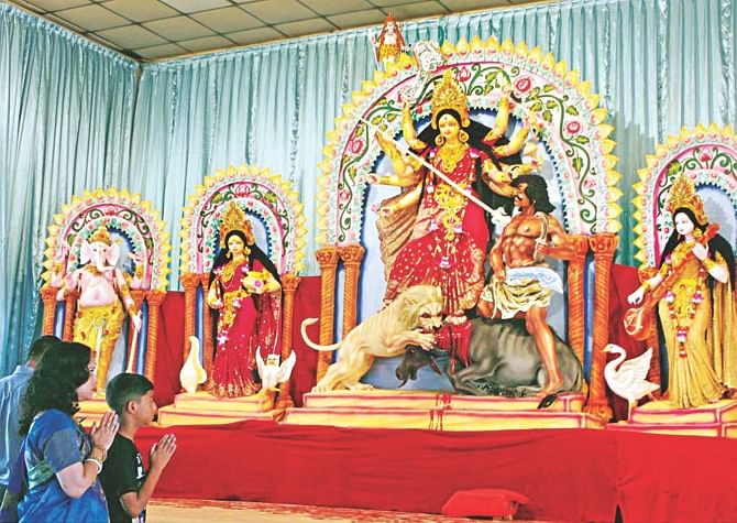 Hindus worship at Dhakeshwari National Temple in the capital as Durga Puja, the biggest religious festival of the community, started yesterday. photo: Banglar Chokh