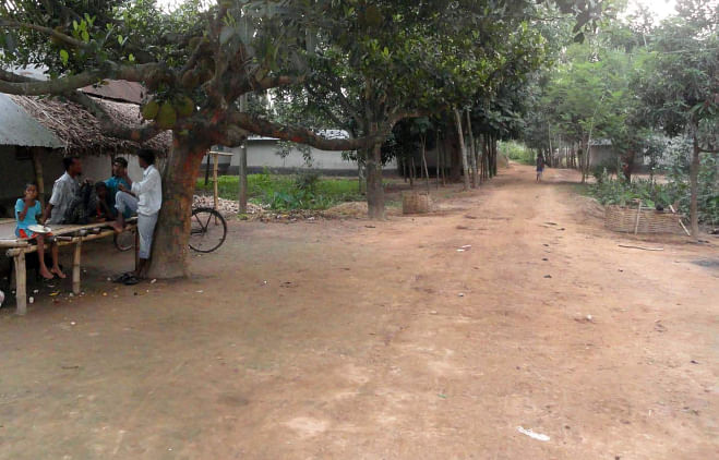 Khalippur village in Nawabganj upazila of Dinajpur wears a deserted look as most of the members of 60 Santal families of the village stay inside their houses, fearing fresh attacks by the criminals who brutally tortured four members of the community on May 9. The photo was taken on Wednesday. Photo: Star