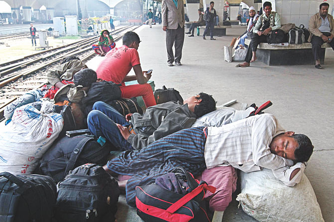 People fall asleep at Kamalapur Railway Station while waiting for trains yesterday as the railway suffers a schedule disaster due to the blockade. Photo: Anisur Rahman