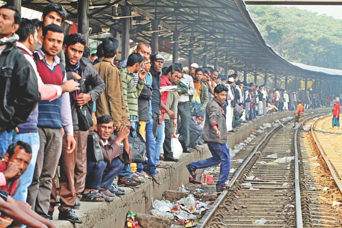 At Banani station, passengers line the rail tracks in wait.  Photo: Amran Hossain