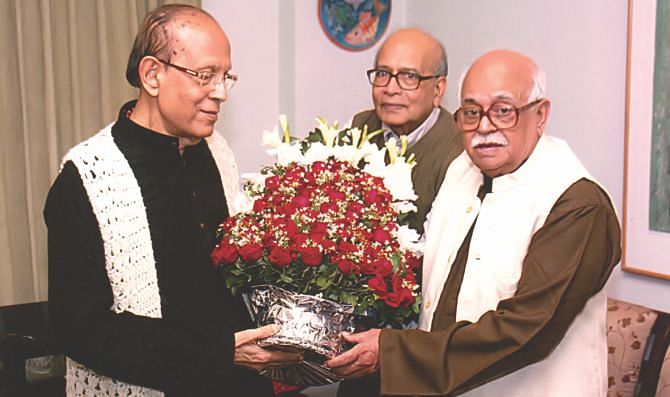 Prof. Zillur R. Siddiqui (R), Prof. Muzaffar Ahmed (C), presenting bouquet of flowers to Prof. Khan Sarwar Murshid on his 88th birthday in 2011.