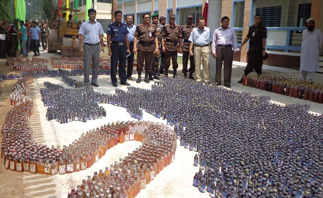 Huge quantity of contraband drugs, including wine, phensidyl and hemp, seized during several drives recently, are kept on the premises of Lalmonirhat Government College prior to their destruction yesterday, marking International Day against Drug Abuse and Illicit Trafficking. PHOTO: STAR