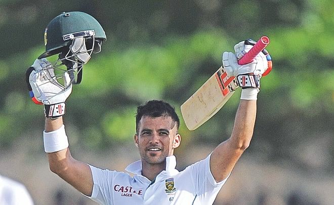 South Africa's JP Duminy raises his bat and helmet in celebration after scoring a century on the second day of the first Test against Sri Lanka at the Galle International Cricket Stadium yesterday. PHOTO: AFP