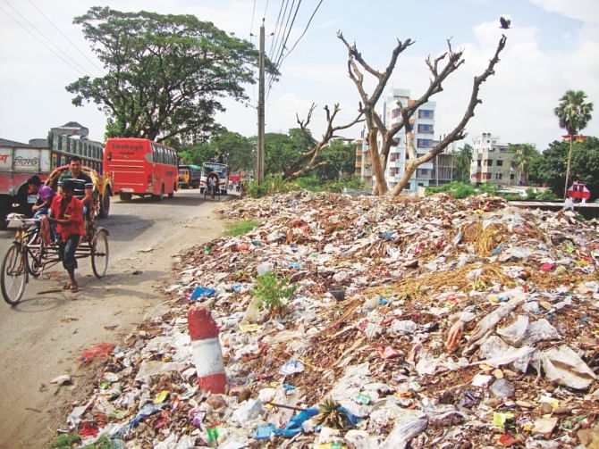 Random dumping of garbage, including toxic items, wreaks havoc to roadside trees in Brahmanbaria municipality. The photo was taken from the town bypass a few days ago.  PHOTO: STAR