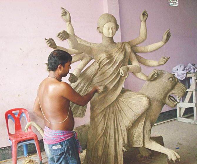 An artiste busy preparing an idol at Maa Shankari Kali Mandir (temple) at Guripara in Chapainawabganj town as the Durga Puja festval is only two weeks away. PHOT: STAR