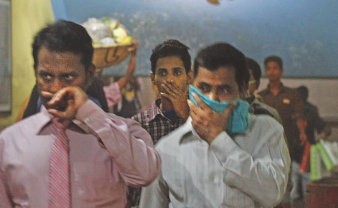 Some using handkerchiefs over their mouths while passing through.Photo: Rashed Shumon/Amran Hossain