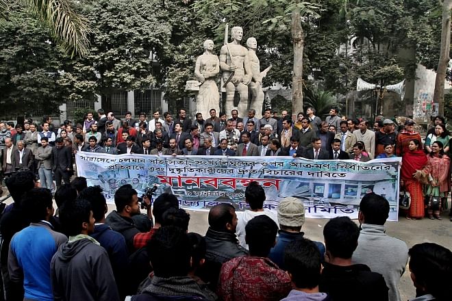 Dhaka University Teachers' Association forms a human chain in front of Aparajeya Bangla on the campus yesterday, protesting against the post-election attacks on the minority communities across several districts and immediate arrest and trial of the perpetrators. Photo: Star