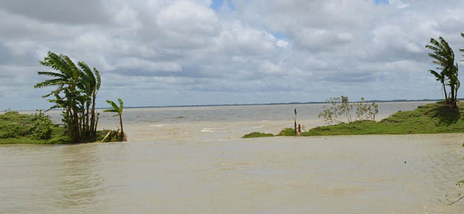 Saline water from Ramnabad River enters the villages and agricultural land through the breached portion of the flood control embankment in Lalua union under Kalapa upazila of Patuakhali. Photo: Star