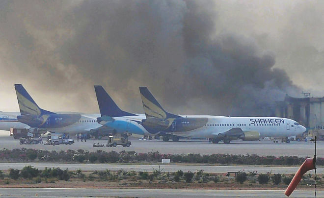 Smoke rises after militants launched an early morning assault at Jinnah International Airport in Karachi yesterday. Pakistan's security forces said they had relaunched a military operation at Karachi airport as gunfire resumed several hours after they announced the end of a militant siege that left 28 dead. Photo: AFP