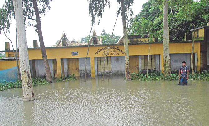 Flood water swamps Gozaria Government Primary School in Shariakandi upazila of Bogra. This is one of the 18 primary schools closed amid flood in the upazila. Photo: Star
