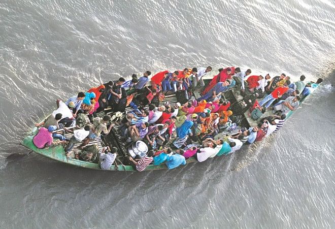 A boat leaves Dhaka with people eager to meet family members and spend the Eid holidays. The photo was taken from Postogola bridge on the river Buriganga yesterday. Photo: Amran Hossain