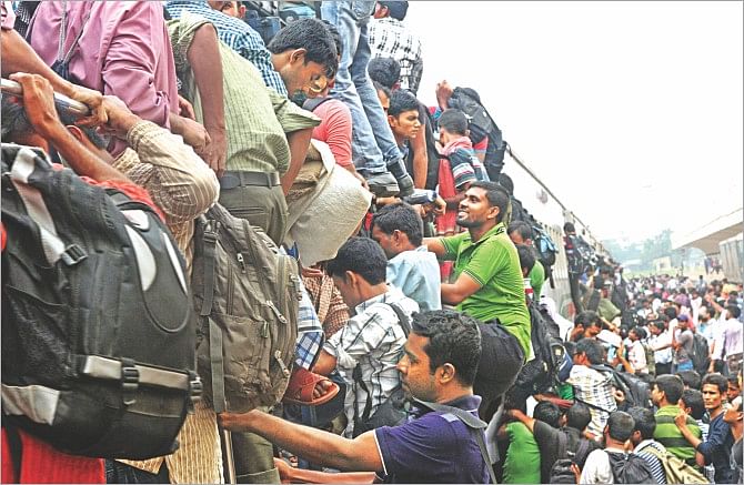 Desperate to go home before Eid, people at Kamalapur Railway Station yesterday risk their lives trying to get on an already-overcrowded train. There was a potential of a stampede and police eventually had to charge truncheons on passengers to get them off a locomotive. Photo: Sk Enamul Haq 