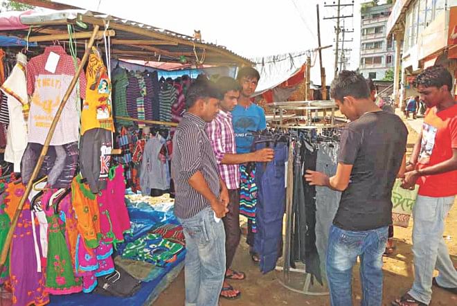 A makeshift shop of low priced clothes set up before a garment factory in Abdar village of Gazipur, targeting RMG workers.  Photo: Star