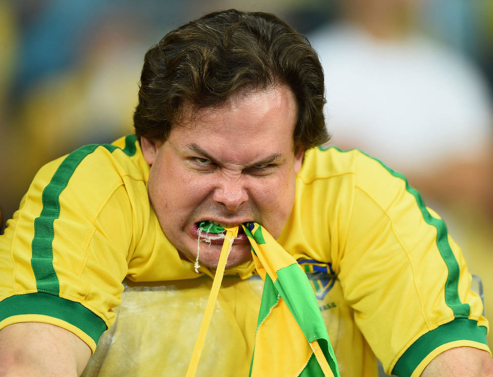 An emotional Brazil fan reacts after being defeated by Germany 7-1 after the 2014 FIFA World Cup Brazil Semi Final match between Brazil and Germany at Estadio Mineirao on July 8, 2014 in Belo Horizonte, Brazil. Photo: Getty Images