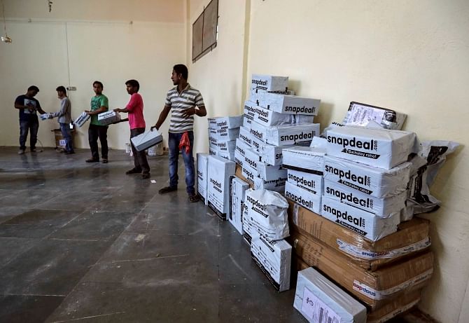 Employees of Snapdeal, an Indian online retailer, sort out delivery packages inside their company fulfilment centre in Mumbai. pHOTO: REUTERS/File