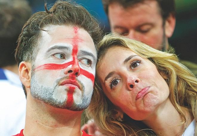 England's defeat is written on the faces of their fans. PHOTO: REUTERS