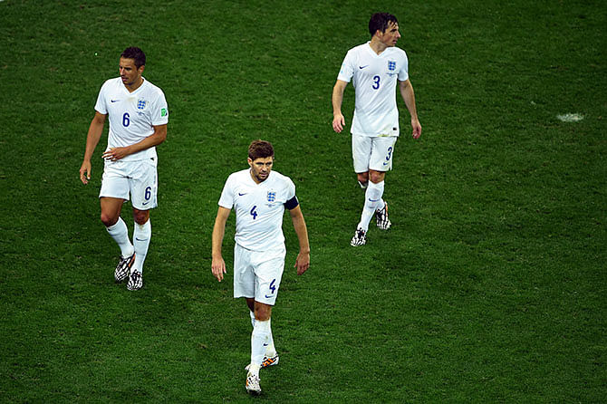 (L-R) A dejected Phil Jagielka, Steven Gerrard and Leighton Baines of England look on after losing to Uruguay 2-1 during the 2014 FIFA World Cup Brazil Group D match between Uruguay and England at Arena de Sao Paulo on June 19, 2014 in Sao Paulo, Brazil. Photo: Getty Images