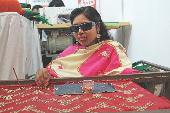 A visually impaired woman, beneficiary of a project implemented by Action on Disability and Development, participates in a fair co-organised by Shiree, Manusher Jonno Foundation and World Food Programme. Photo: Star  