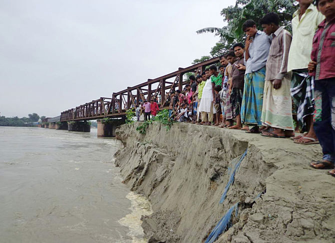 Erosion by the Dudhkumar River threatens Sonahat bridge in Bhurungamari upazila under Kurigram district. PHOTO: STAR
