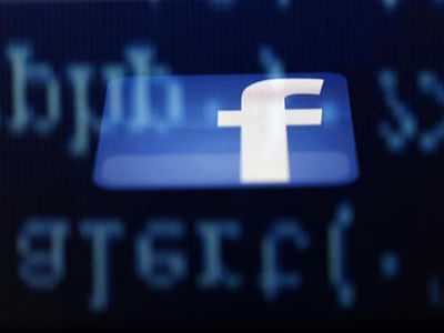 A Facebook logo on an Ipad is reflected among source code on the LCD screen of a computer, in this photo illustration taken in Sarajevo June 18, 2014. Photo: Reuters