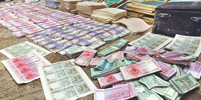 This October 14, 2012 photo shows counterfeit notes of taka and Indian rupee recovered from different areas in the capital.