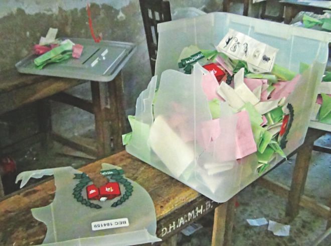Ballot papers torn and boxes vandalised by supporters of BNP favourite Faruk Mia at Alia Madrasa centre in the sadar upazila.  Photo: Star