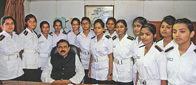 The first batch of the country's female marine cadets selected for sea training, with Shipping Minister Shajahan Khan at Chittagong Port yesterday. The minister handed over the appointment letters to two cadets while the rest of the 13 will get it gradually. They will work on five ships of Bangladesh Shipping Corporation for one year. Photo: Star