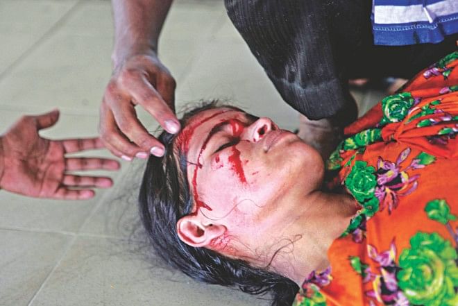 A wounded female worker lying on the road. Photos: Courtesy