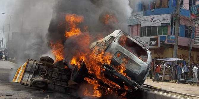 This Star photo taken May 20 shows a car of Phulgazi upazila chairman Ekramul Haque burning after an arson attack in Feni. The easy bike used by the attackers is also in flames.