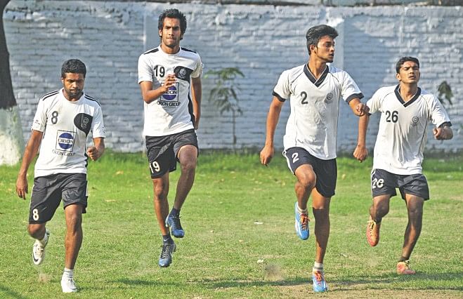 Mohammedan players limber up for a practice session at the club's ground in Motijheel yesterday afternoon. The Black and Whites are preparing for the Modhumoti Bank Independence Cup football tournament final against Feni Soccer Club tomorrow at the Bangabandhu National Stadium. PHOTO: STAR
