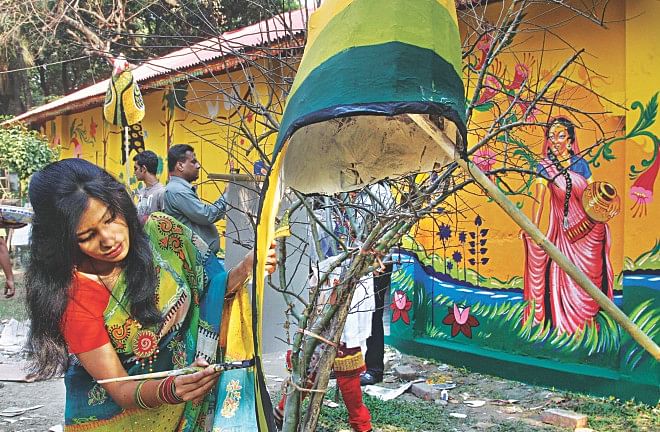 A student puts finishing touches to an artwork at the Faculty of Fine Arts of Dhaka University yesterday afternoon. The item, among others, will be used in the Pahela Baishakh procession in the capital today. Photo: Star