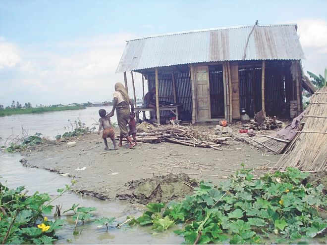 A family of Mollikpara village on the brink of losing their home due to flooding. PHOTO: STAR