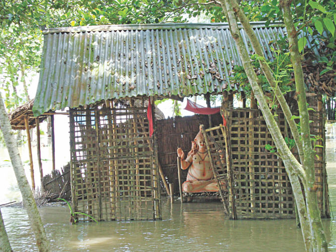 A temple goes under water at Etapota of Lalmonirhat yesterday as the northern region continues to suffer floods. Photo: Star