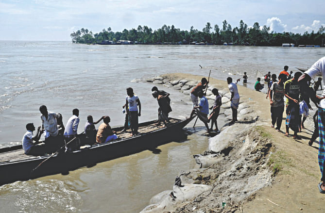 Jamuna washed away 300 metres of a dyke early yesterday flooding homes of thousands and their cropland. Photo: Star