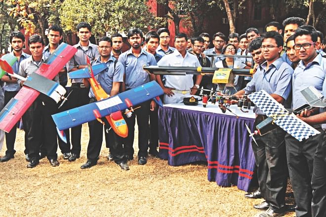 Students of Aeronautical Engineering department of Military Institute of Science and Technology pose with their prototype UAVs on their Mirpur Cantonment campus yesterday. Two of the unmanned planes, the one on the right and the second from left, are heading for competition in the US this year. Bottom, a prototype quadcopter.    Photo: Sk Enamul Haq 
