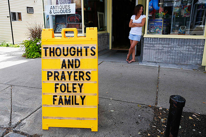 A sign outside a shop remembers James Foley in his hometown of Rochester, New Hampshire August 20. Photo: Reuters  