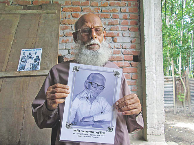 Golam Kobir, brother of Ahsan Habib, holding the poet's picture. Photo: Star