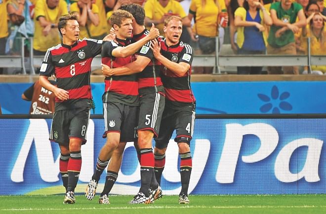 Germany forward Thomas Mueller (2nd from L) celebrates his strike in the 11th minute of their World Cup semifinal against Brazil in Belo Horizonte on Tuesday. Play started with Brazil replacing Neymar with Bernard. The Germans took a 5-0 lead in the game by the 29th minute as Miroslav Klose (23), Toni Kroos (24, 26) and Sami Khedira (29) scored the other goals. PHOTO: AFP