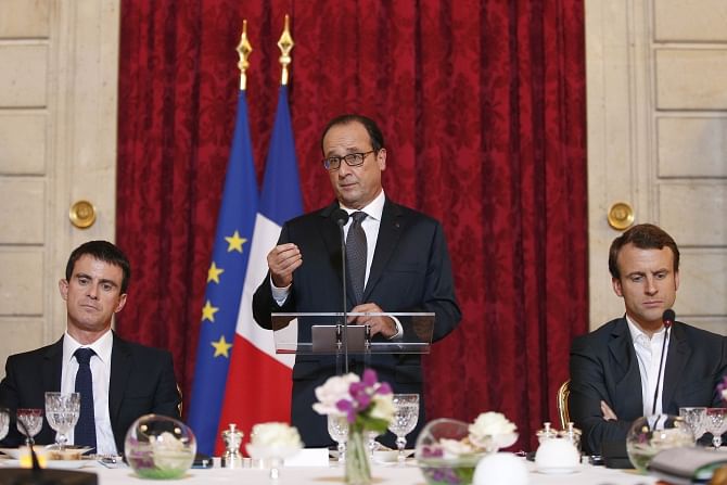 French President Francois Hollande (C) delivers a speech prior to a diner as part of a Strategic Attractiveness Council at the Elysee Palace with French Prime Minister Manuel Valls (L), French Economy Minister Emmanuel Macron (R) and a group of International CEO's, in Paris, on Sunday. Photo: AFP 