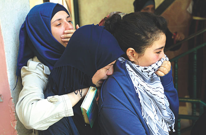 Relatives of killed Palestinian Mohammed al-Araj grieve during his funeral at the Qalandia Palestinian refugee camp near the West Bank city of Ramallah yesterday after he was shot and killed the night before during clashes with Israeli troops.  Photo: AFP