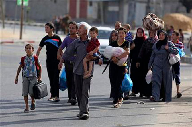 Palestinians flee their homes to take shelter at the United Nations school in Gaza City, Sunday. Photo: AP