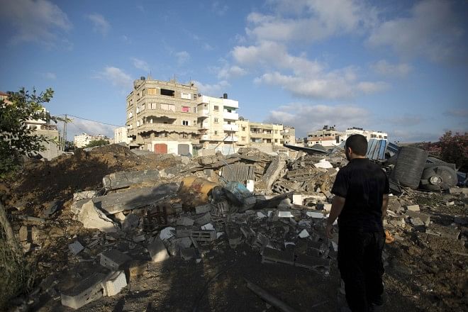 A Palestinian man inspects damages following an overnight Israeli air strikein Gaza City, yesterday.  Photo: AFP