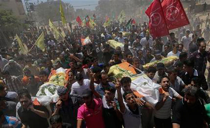 Palestinians carry bodies of seven people killed in a strike during their funeral in Khan Younis refugee camp in the southern Gaza Strip July 9. Photo: AP